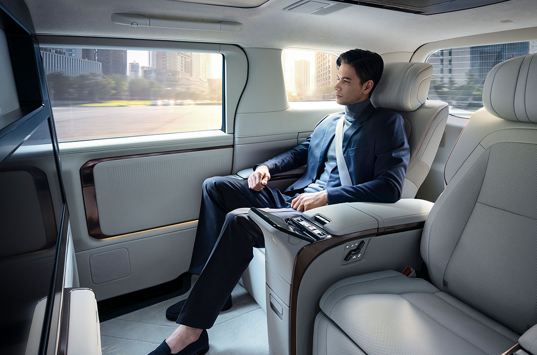 Man enjoys the opulent interior of the Lexus LM rear seats.